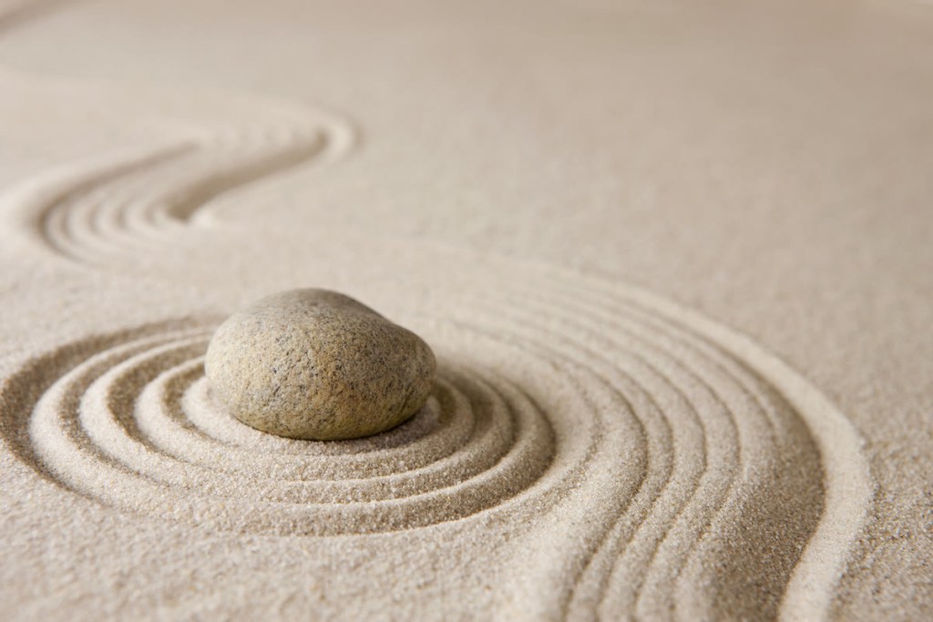 Zen stone with flowing sand lines – 30-day transformation coaching program